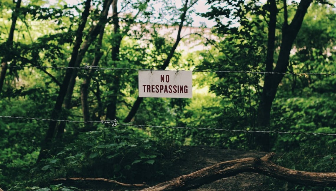 Sign of no trespassing in the woods