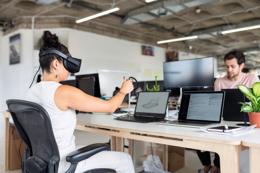 a woman on her worktable wearing a VR headset